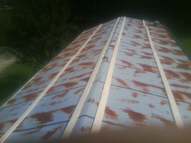 Rusted metal roof panels with new wood purlins before replacement — Storm Damage Roof Repair in Mellott by Roofing Brothers