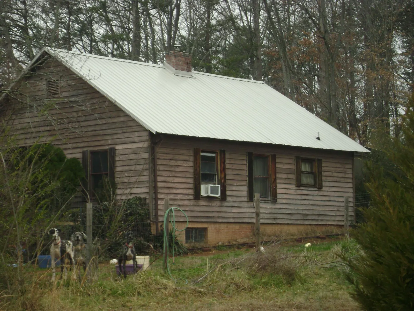 White metal roof on an old wood sided farmhouse, from a Metal Roof Installation job in Mellott